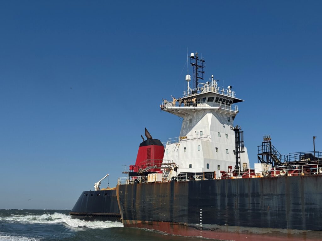 Crew of the Crowley Liberty wave to pilots in Louisiana as the ATB prepares to sail to Florida.