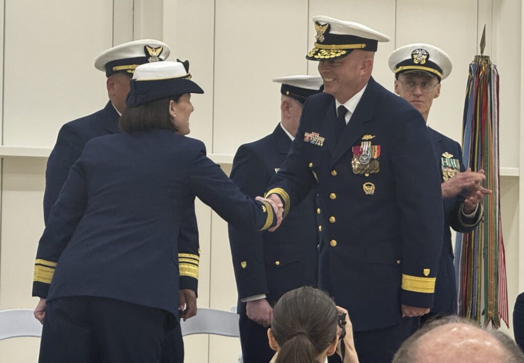 Rear Adm. Bob Little, the new commander of the Coast Guard’s Arctic sector, smiles as he shakes hands with Rear Adm. Megan Dean, the departing commanding officer, during a change of command ceremony Friday, July 11, 2025, in Juneau. (Photo by James Brooks/Alaska Beacon)