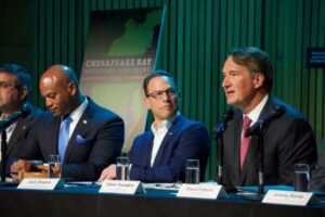 Virginia Gov. Glenn Youngkin (R) speaks at Tuesday’s meeting of tbe Chesapeake Executive Council at the National Aquarium. (Photo by Christine Condon/Maryland Matters)