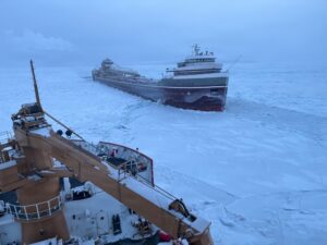 Coast Guard Cutter Mackinaw (WLBB 30), a Great Lakes District ice-breaking cutter, arrives on scene to assist the motor vessel Wilfred Sykes, a lake freighter, beset by ice on Lake Huron Jan. 21, 2026. (U.S. Coast Guard photo by Lt. j.g. William Erekson).