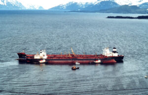 Prince William Sound, AK (Mar. 24)--The Exxon Valdez remains in place in Prince Williams Sound after running aground. The Exxon Valdez ran aground on Bligh Reef in Prince William Sound, Alaska, March 23, 1989 spilling 11 million gallons of crude oil, which resulted in the largest oil spill in U.S. history. U.S. COAST GUARD PHOTO