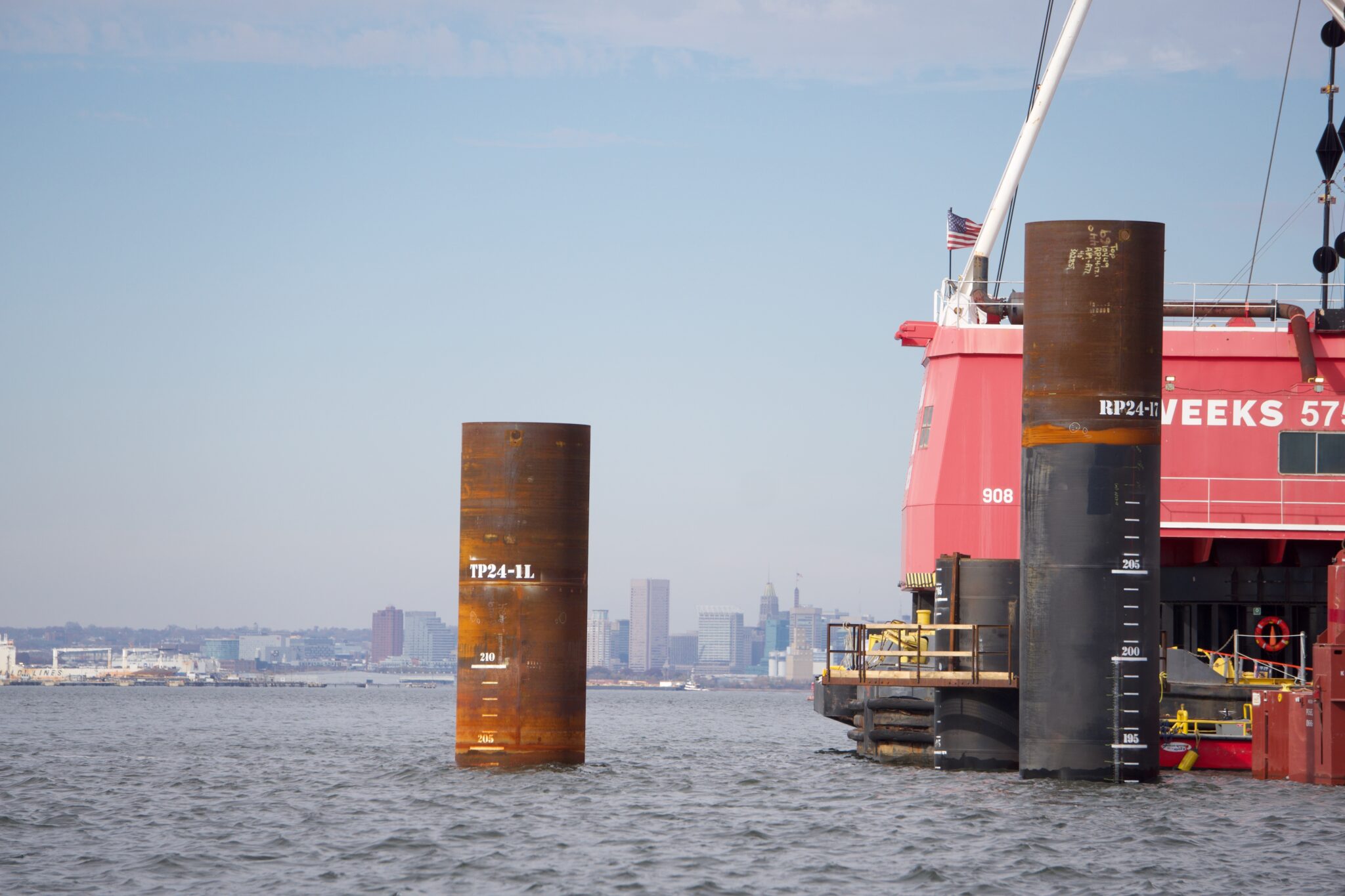 Two massive steel piles are submerged in the Patapsco River bed on Nov. 5 2025 in preparation for the new Francis Scott Key Bridge (Photo by Christine Condon Maryland Matters)